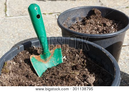 Flowerpot With Loam And Gardening Trowel Before Planting Flowers