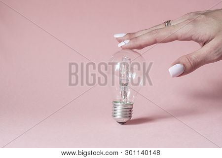 Close Up View Of White Light Bulb Isolated On Pink.