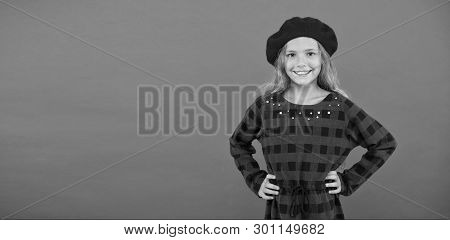 Wear Beret Like Fashion Girl. Kid Little Cute Girl With Long Blonde Hair Posing In Beret Hat And Che