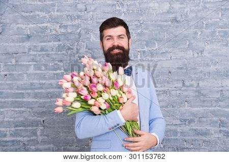 Spring Style. Womens Day Is On March 8. Spring Gift. Bearded Man Hipster With Flowers. Love Date. In