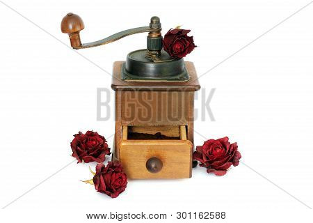 Manual Coffee Grinder With Roses On A White Background. Antiquary