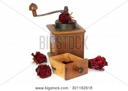 Manual Coffee Grinder With Roses On A White Background. Antiquary