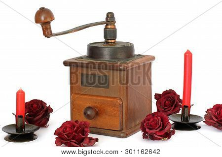 Manual Coffee Grinder With Roses On A White Background. Antiquary