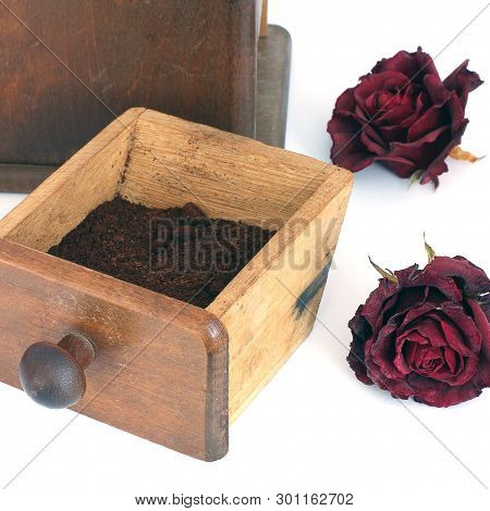 Manual Coffee Grinder With Roses On A White Background. Antiquary