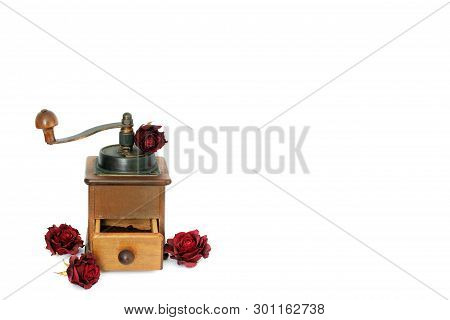 Manual Coffee Grinder With Roses On A White Background. Antiquary