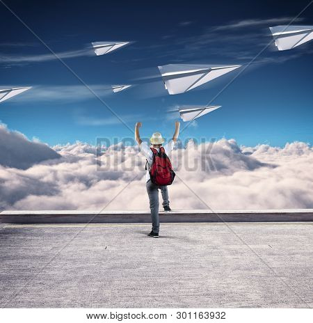 Young Man With Backpack Celebrating Paper Airplanes Race At High Altitude