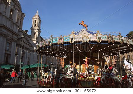 Rome, Italy-december 28 2018: Tourists Crowd Piazza Navona With The Ancient Carousel Of Horses, At T