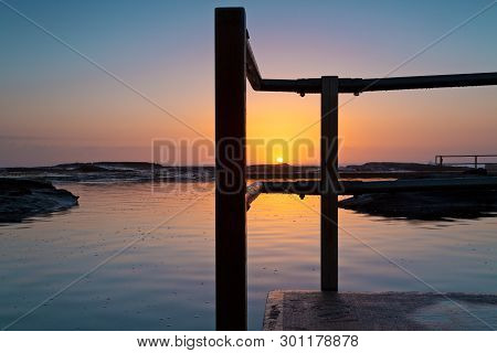 Glorious Tranquil Sunrise On The Ocean Horizon And Ocean Pool Ripples And Reflections. Location - No