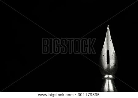 Macro Image Of A Pen Nib Against A Black Background