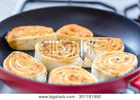 Close Up Of Fresh Grilled Tortilla Wraps With Filling. Fried Tortilla Rolls In A Pan. Selective Focu