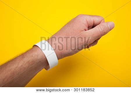 White Wristband, Bracelet Mockup For Event On Yellow Background.