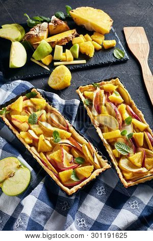 Delicious Pineapple And Apple Sweet Tart In Rectangular Tart Pans On A Concrete Table With Kitchen T