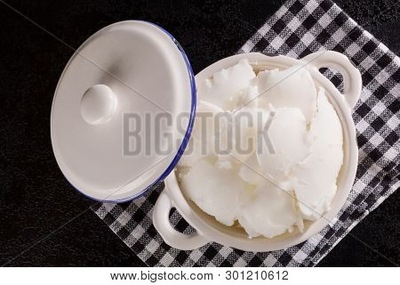Lard Of Pig Fat In Ceramic Pot On Dark Background From Above.