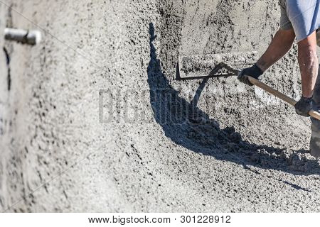 Pool Construction Worker Working With A Bullfloat On Wet Concrete