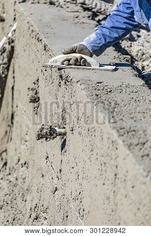 Pool Construction Worker Working With Wood Float On Wet Concrete