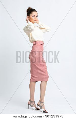 Model In Shirt Of Milk Color, Pink Suede Skirt With Belt, White Heeled Sandals Isolated On White Bac