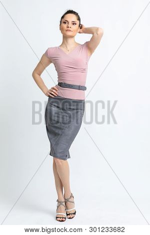 Model In Light Lilac Blouse, Grey Suede Skirt With Belt, White Heeled Sandals Isolated On White Back