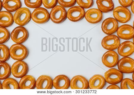 Drying Or Bagels On A White Background, Place For Text, Bright Colors, High Contrast.