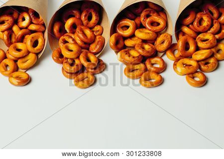 Bagels, Packaged In Paper Bags On A White Background, Space For Text, High Contrast, Bright Colors.