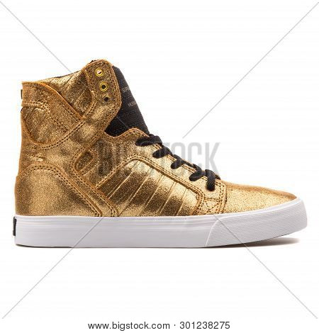 Vienna, Austria - August 10, 2017: Supra Kids Skytop Gold Sneaker On White Background.