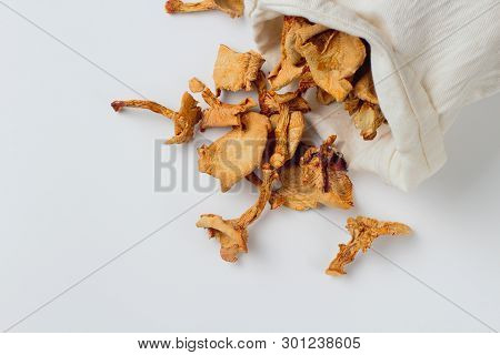 Dried Chanterelle Mushrooms In A Rag Pouch Scattered On A White Background, Place Fot Text. Natural 
