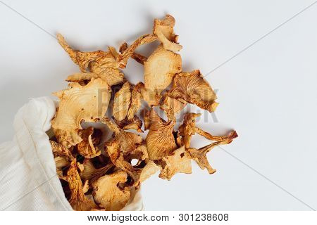 Dried Chanterelle Mushrooms In A Rag Pouch Scattered On A White Background, Place Fot Text. Natural 