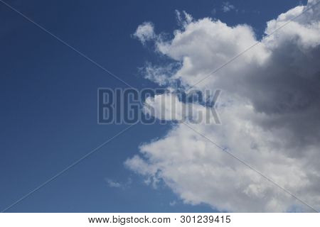 Dramatic Clouds On A Dark Blue Background, Plenty Of Space For Text. High Contrast, Large Image Size