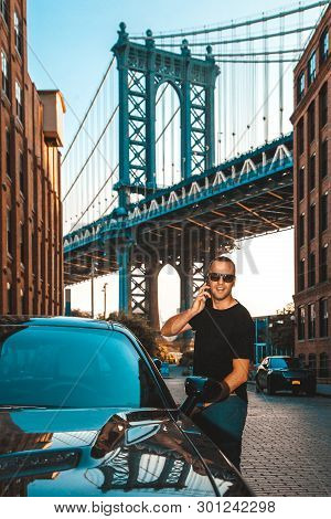 Businessman Handsome Model Talking On His Cell Phone With Manhattan Bridge In Background Between Man