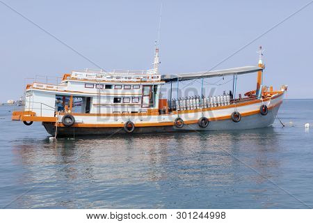 Scuba Diving Tour Boat Floaing Against Clear Blue Sea Water In Thailand