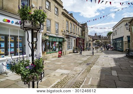 Corsham, Uk - July 17: A Person Rides His Bike In A Street In Corsham, An Old Village In South Of En