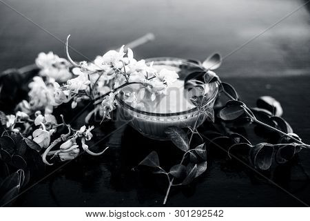 Ayurvedic Herb Drumstick Flowers Along With Some Leaves On Wooden Surface Along With Its Paste In A