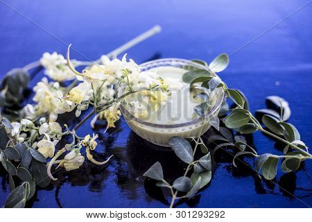 Ayurvedic Herb Drumstick Flowers Along With Some Leaves On Wooden Surface Along With Its Paste In A 