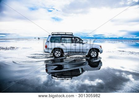 Salar de Uyuni, Bolivia - Dec, 31, 2018: Off-road car driving through Salar de Uyuni salt flat in Bolivia
