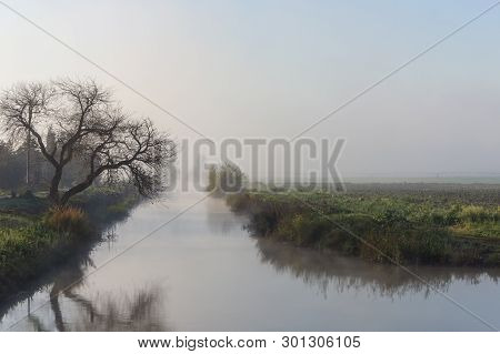 Nature Fog Landscape At Sunrise With River In The Hula Valley, In Israel