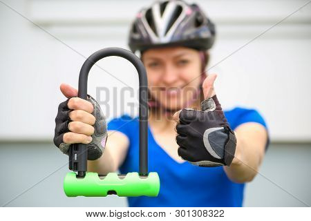 Girl with bicycle  lock. Bicycle U- lock. Bike protection