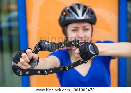 Girl with bicycle  lock. Bicycle lock. Bike protection