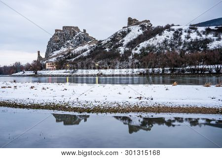 Snow Covered Devin Castle Ruins Above The Danube River In Bratislava, Slovakia In The Morning