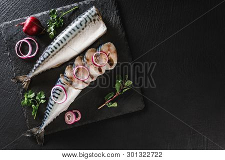 Marinated Mackerel Or Herring Fish With Spices, Greens And Onion On Slate Stone Background. Mediterr