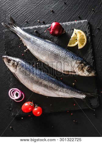Marinated Whole Mackerel Or Herring Fish With Spices, Lemon And Onion On Slate Stone Background. Med