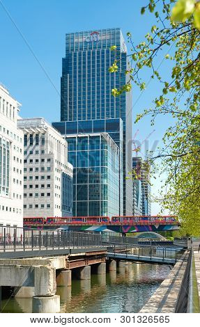 London, England - May 5, 2013: Overground Dlr Train Approaches Canary Wharf, Dlr Station In London S
