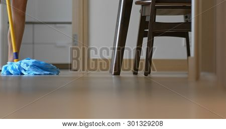 Housewife clean floor with mop