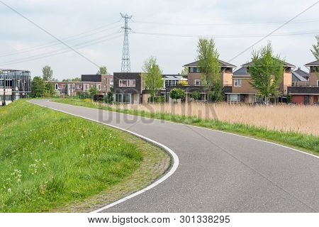 Empty Curved Road On A Dam In The Dutch Countryside, Capelle Aan Den Ijssel, Netherlands