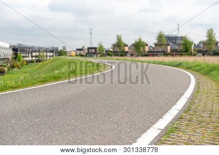Empty Curved Road On A Dam In The Dutch Countryside, Capelle Aan Den Ijssel, Netherlands