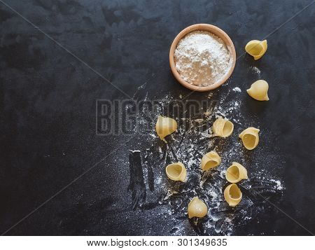 Uncooked Dry Delicious Italian Pasta Lumaconi In The Hand. Top View.