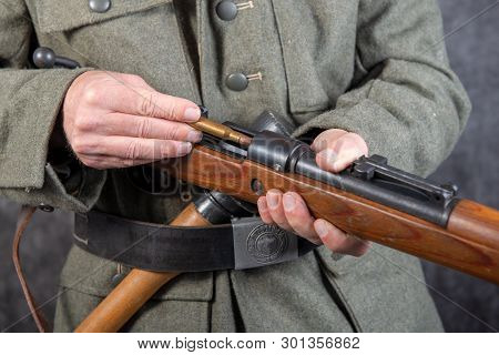 A Ww Ii German Soldier With Rifle And Ammunition