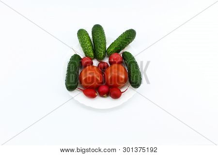 The View From The Top. Light Background. In A Round White Plate Are Vegetables: Cucumbers, Tomatoes 