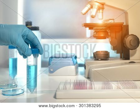 Scientific Background With Microscope Room. Shallow Dow, Toned Image. Focus Here Is On A Liquid Samp
