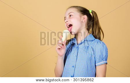 Ice Cream Makes Her Happy. Cute Little Girl Eating Ice Cream. Small Child Licking Ice Cream In Cone.