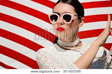 Portrait Of A Pretty Young Woman In White Lace Dess, White Pearl Necklace And  Sunglasses With Neon 