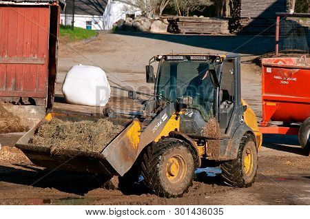 Rowley, Massachusetts, April 28, 2019: The 204k John Deere Front End Loader Hauling Silage Is A Prod